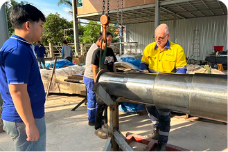 oil-worker-orange-uniform-helmet-working-with-pipe-wrench-near-oil-pump-jack 1